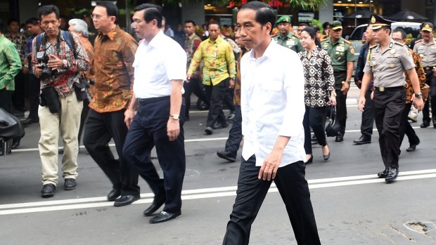 Indonesian President Joko Widodo, centre, visits the site of last week's terror attacks in Central Jakarta.