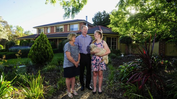 Downsizing:  David and Helen Maybin with their daughter Tara,15, are selling their family home in Fadden.