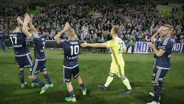 Melbourne Victory players acknowledge their fans after their semi-final match win against Brisbane Roar on Sunday. 