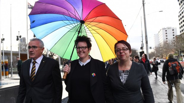 Mother-of-three Felicity Marlowe (centre) and her partner Sarah Marlowe with MP Andre Wilkie after appearing for a High Court injunction hearing application against the voluntary same-sex marriage postal survey.