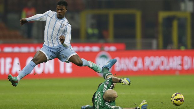 AC Milan goalkeeper Christian Abbiati blocks Lazio's Balde Diao Keita.