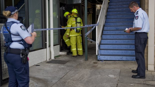 Fire crews and police investigating the alleged arson at the Brierly Street cafe in Weston in March 2014.