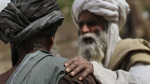 Afghan tribal leaders confer after praying in Helmand, Afghanistan. 