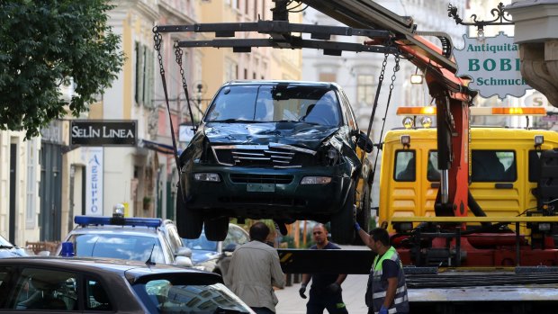 The van of a man who drove into a crowd is being removed from the street.