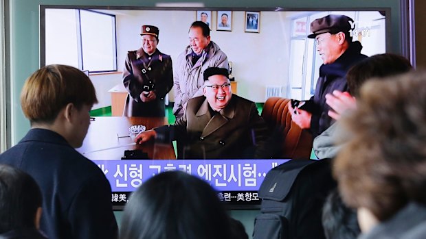 Viewers at Seoul Railway station watch North Korean leader Kim Jong-un at the country's Sohae launch site.