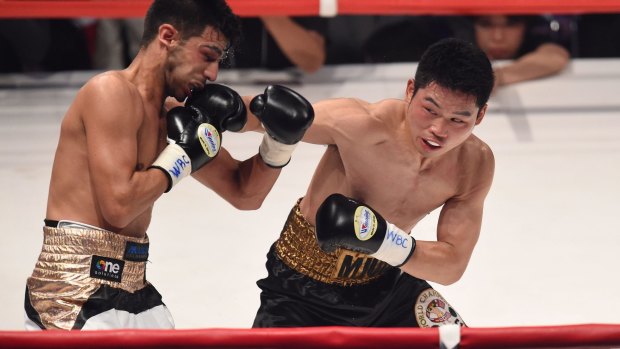 Takashi Miura lands a punch on Billy Dib's chin.