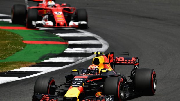 Mid-race tussle: Max Verstappen of the Netherlandsg leads Sebastian Vettel of Germany during the British Grand Prix.