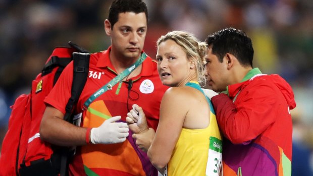 Mickle is assisted by medical staff after dislocating her shoulder at the Rio Olympics.