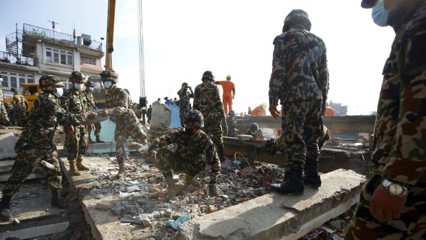 Soldiers from the Nepalese army clear debris from a collapsed house while searching for victims in Kathmandu.