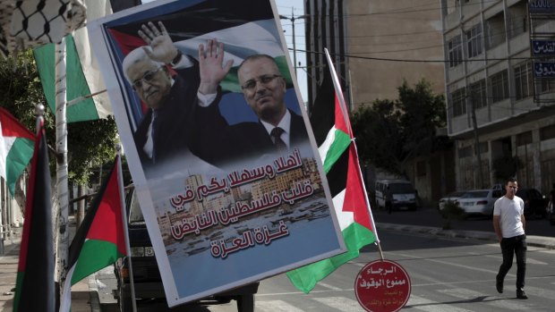 A poster of Palestinian President Mahmoud Abbas and PM Rami al-Hamdallah hangs on a street in Gaza City.