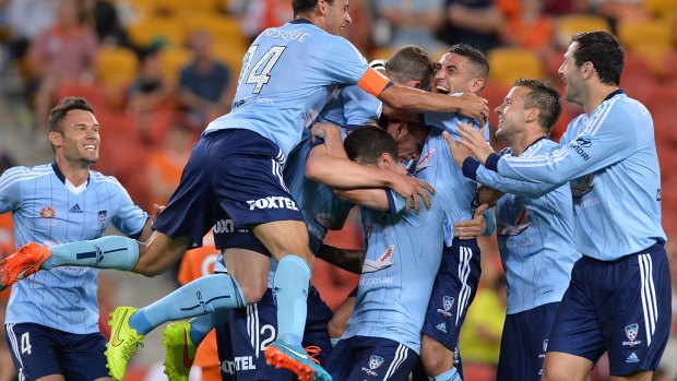 Marc Janko is mobbed by teammates after his extraordinary strike.