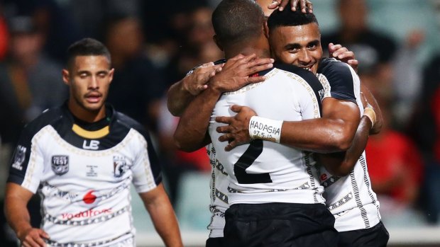 Star in the making: Etuate Qionimacawa (R) of Fiji celebrates after scoring a try.