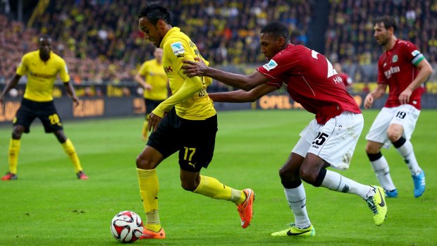 Pierre-Emerick Aubameyang of Dortmund is pulled back by Marcelo of Hanover.