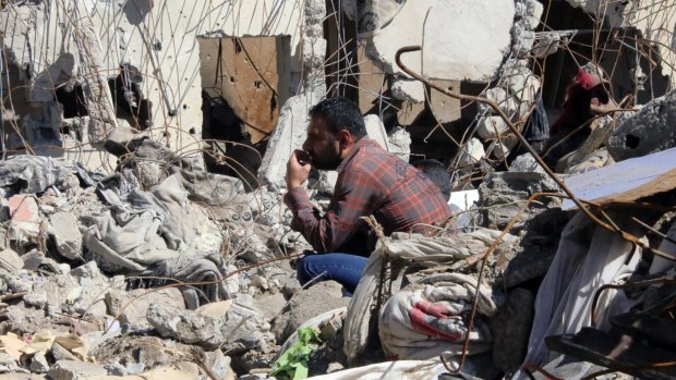 A man sits among the debris of his ruined house in Cizre, Turkey, on Wednesday.