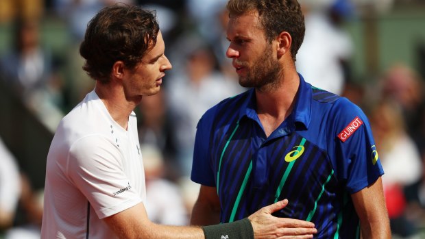 Reaching out: Andy Murray consoles Mathias Bourgue.