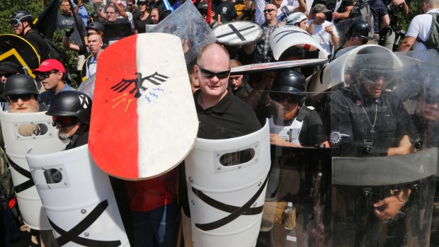 White nationalist demonstrators use shields as they guard the entrance to Emancipation Park in Charlottesville on August 12.