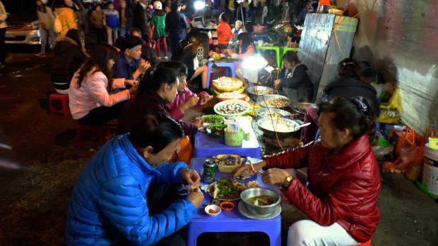 Locals eat at Da Lat night market.