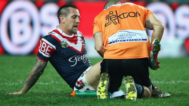 Ouch: Mitchell Pearce receives attention from the trainer.