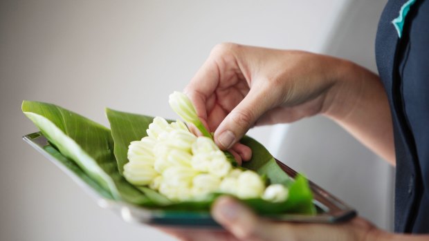 The fragrant tiare flowers are offered to every passenger.