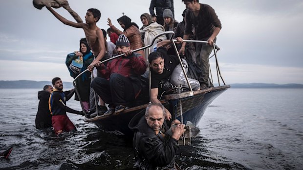 A small boat filled with migrants comes ashore in Greece after crossing from Turkey. Many migrants then head to France, Germany or Sweden for asylum. 