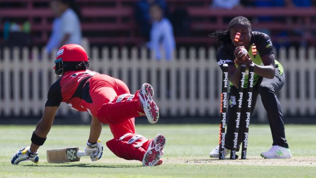 Safe: Chamari Attapattu of the Renegades makes her ground after an unsuccessful stumping attempt by Stafanie Taylor of the Thunder.