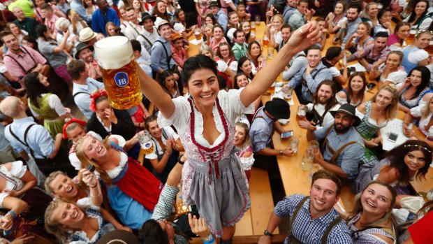 A young woman celebrates the opening of 'Oktoberfest' beer festival in Munich.