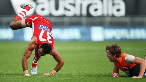 Fully committed: Adam Goodes takes a tumble.