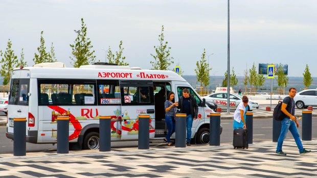 Passengers leave the shuttle at bus stop at the airport Platov. Photo: hutterstock