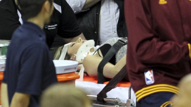 Ellie Day, wife of PGA Tour golf player Jason Day, is carried off the floor in a stretcher after Cleveland Cavaliers' LeBron James collided with her out of bounds.  