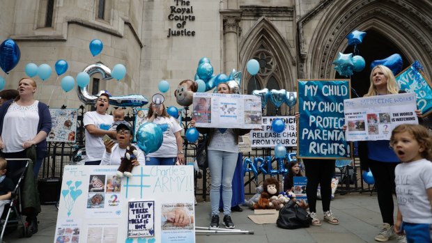 Supporters of Charlie Gard hold placards outside the court in London.