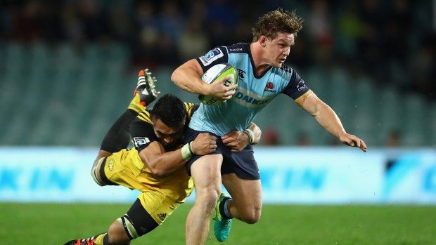 One-man band: Michael Hooper is tackled during the round 16 Super Rugby match between the Waratahs and the Hurricanes at Allianz Stadium.