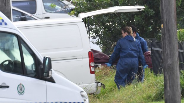 Qin Wu's body is removed from the Guildford house in February.