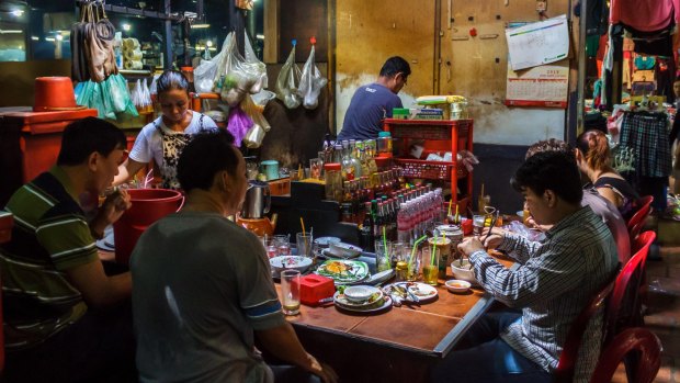 Customers eat lunch in the Russian market in Phnom Penh. 