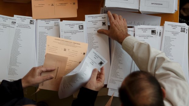 Spanish voters  collect their ballot papers at a polling station in Madrid on Sunday.