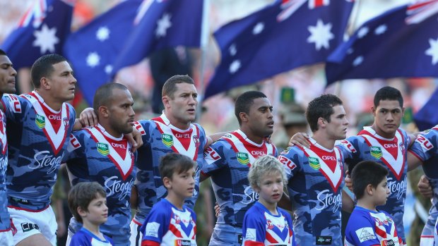 Roosters players pause for a minute’s silence before the 2013 clash with St George Illawarra.