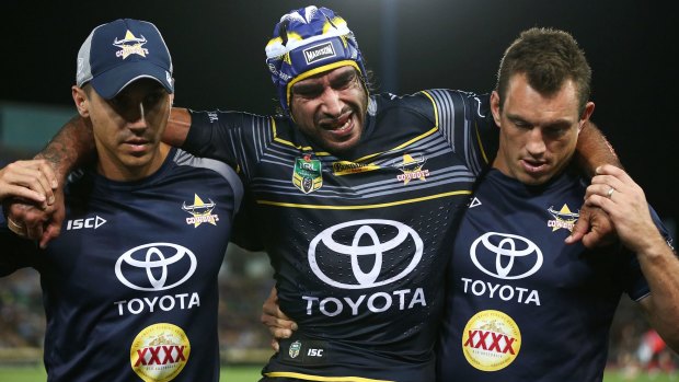 Sorry sight: Johnathan Thurston is helped off the field.