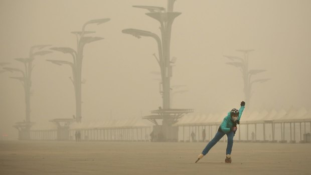 A woman wearing a mask practises roller blading at Olympic Park, Beijing, earlier in the month.