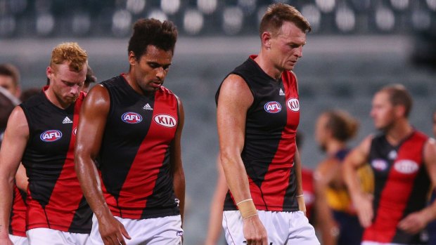 Reality check: Brendon Goddard leads the Bombers off after their loss to West Coast.