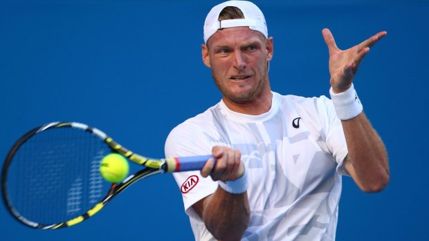 Sam Groth of Australia plays a forehand in his first round match.