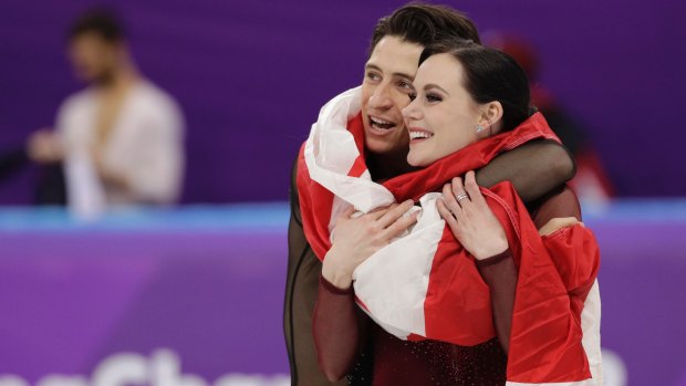Tessa Virtue and Scott Moir of Canada celebrate after winning the gold medal in the free dance figure skating final at the Winter Olympics.