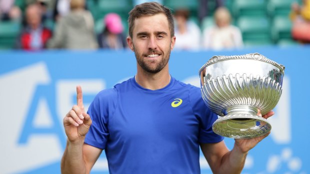 Triumphant: Steve Johnson poses with his trophy after defeating Pablo Cuevas in his men's singles final of the Nottingham Open.