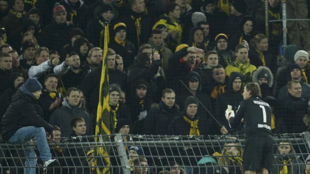 Borussia Dortmund's goal keeper Roman Weidenfeller talks to supporters following his team's defeat by FC Augsburg.