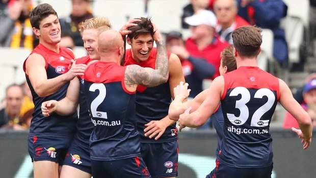 The Demons get around first-gamer Sam Weideman after he kicked a goal with his first kick in the AFL.
