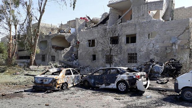 Several damaged cars along the road to the airport in southeast Damascus, Syria, Sunday, July 2, 2017.