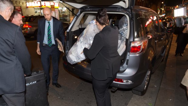 Australian Federal Police remove shredded documents and other evidence during a raid on the Australian Workers Union offices in Sydney on Tuesday.