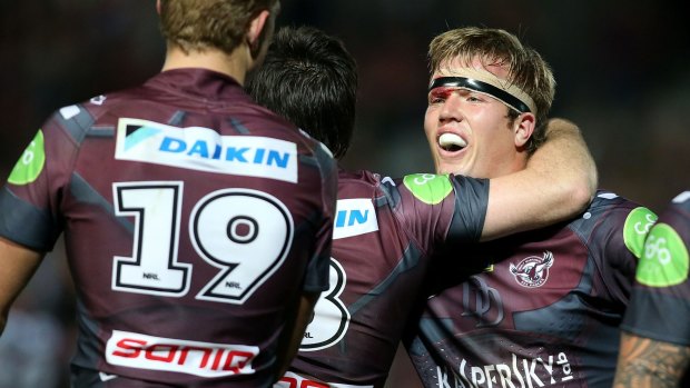 Job well done: Manly's Jake Trbojevic celebrates with teammates after his team's win over Brisbane. 