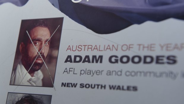 The damaged plaque, on the shores of Lake Burley Griffin, displaying the image of Adam Goodes, Australian of the Year 2014. 