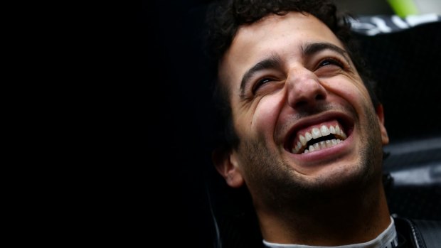 Smiling assassin: Red Bull driver Daniel Ricciardo grins as he sits in his car in the garage during day three of the final Formula One Winter Testing at Circuit de Catalunya last week in Montmelo.