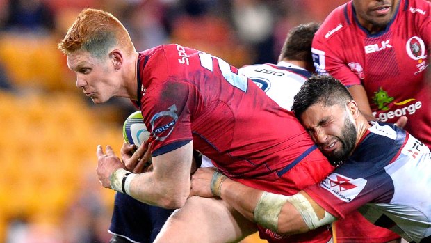 Team puts in forgettable season: Campbell Magnay takes on the Rebels defence for the Reds.