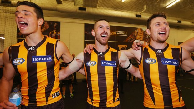 Happy team: Whitecross (centre) sings the club song after the round 23 win over Collingwood.